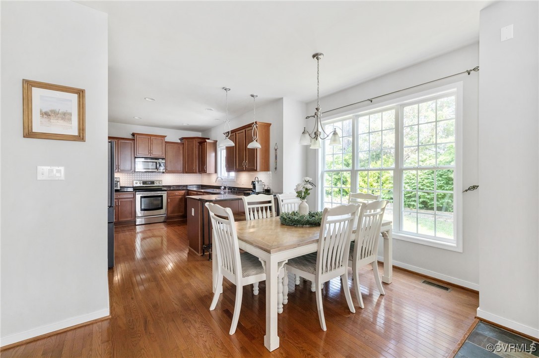 14300 Wallingham Loop Midlothian, VA 23114 - Photo 27 of 50 a view of a dining room with furniture window and wooden floor