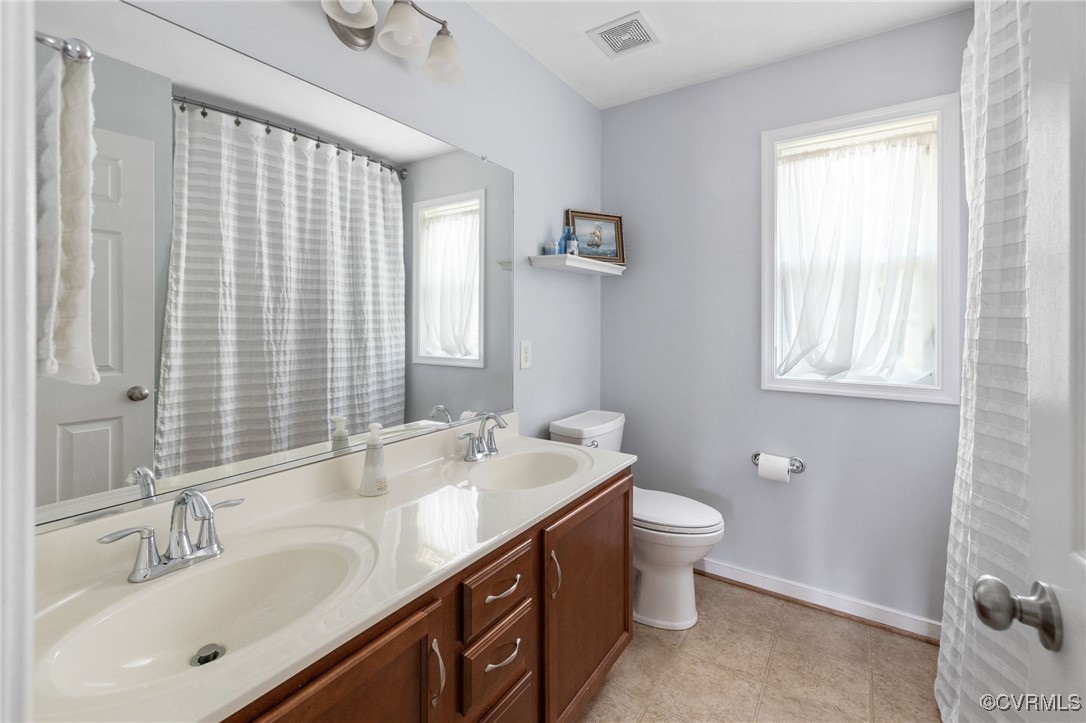 14300 Wallingham Loop Midlothian, VA 23114 - Photo 40 of 50 a bathroom with a double vanity sink toilet and a mirror