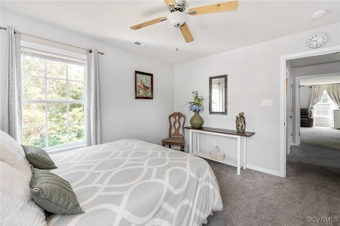 14300 Wallingham Loop Midlothian, VA 23114 - Photo 42 of 50 a bedroom with a bed and a chandelier