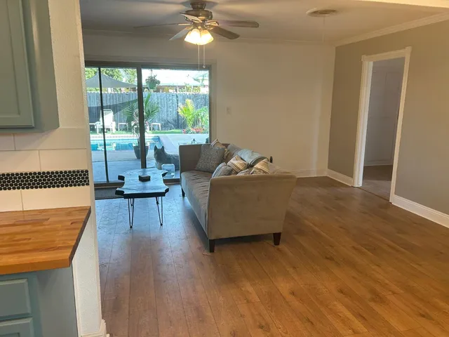 a kitchen with stainless steel appliances kitchen island granite countertop a refrigerator and a stove top oven