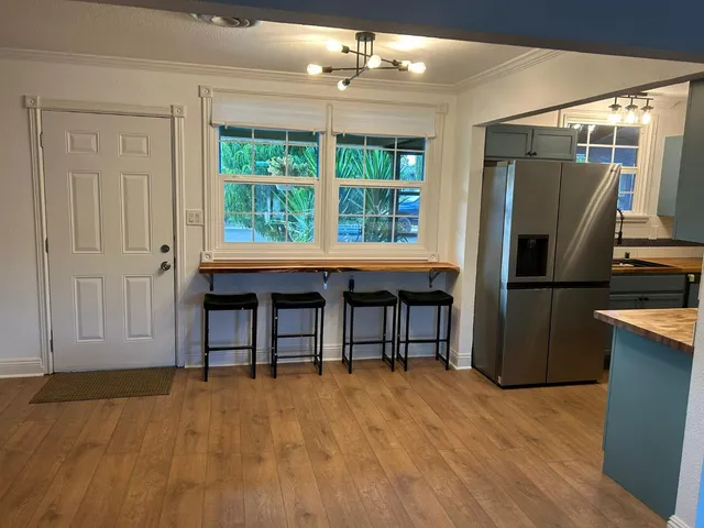 a kitchen with kitchen island a counter top space cabinets and stainless steel appliances