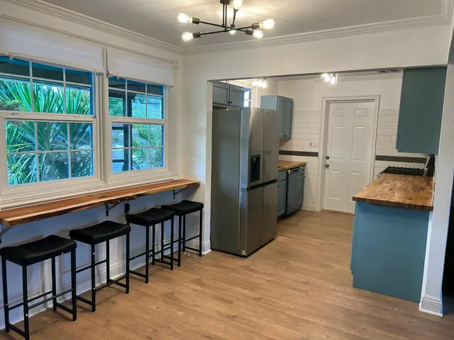 a kitchen with refrigerator and window