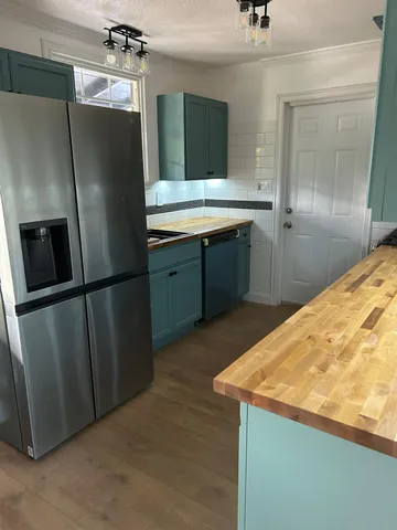 a blue bed sitting in a bedroom next to a window