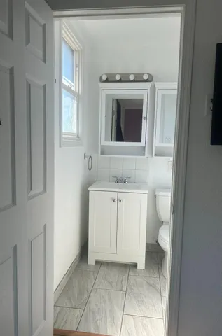 a roof deck with table and chairs