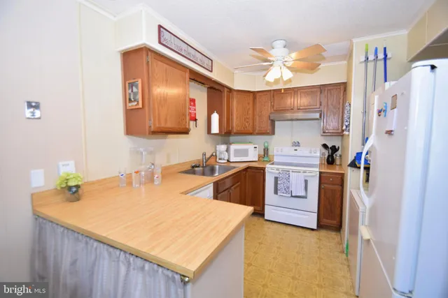 a kitchen with a sink a stove a refrigerator and a refrigerator