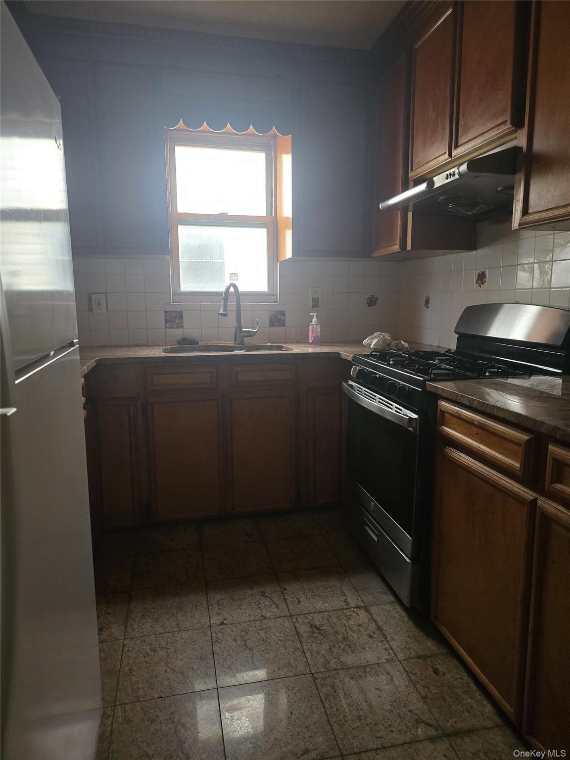 94-18 130th Street Queens, NY 11419 - Photo 6 of 9 a kitchen with stainless steel appliances a stove a sink and a refrigerator
