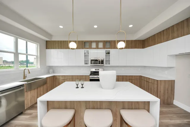 a kitchen with a table chairs in it and wooden floors