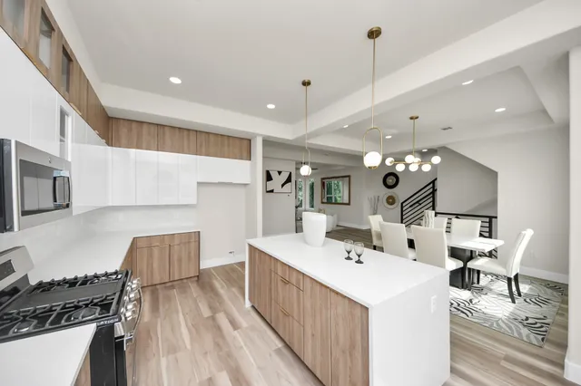 a kitchen with a sink stove and cabinets