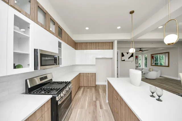 a kitchen with sink stove and refrigerator