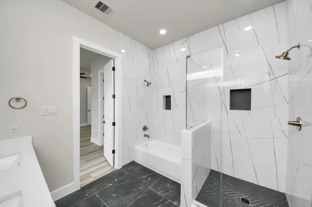 a bathroom with a sink and shower