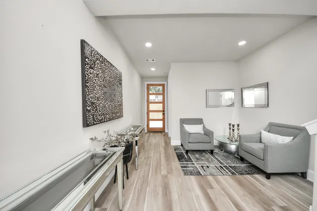 a living room with furniture and wooden floor