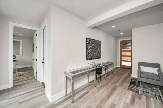 a living room with furniture and a wooden floor