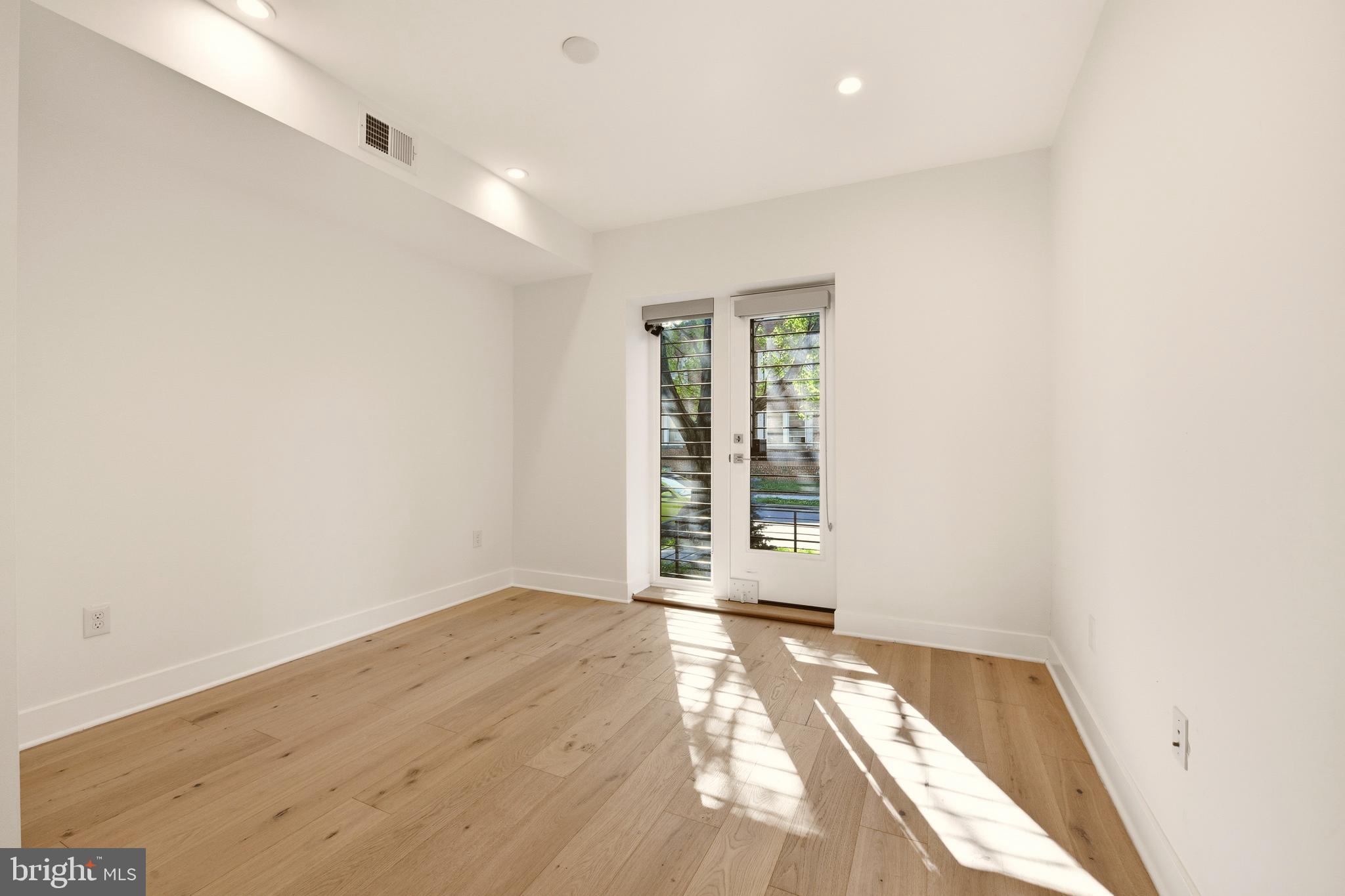 1023 16th Street Northeast, Unit B Washington, DC 20002 - Photo 12 of 25 an empty room with wooden floor and windows