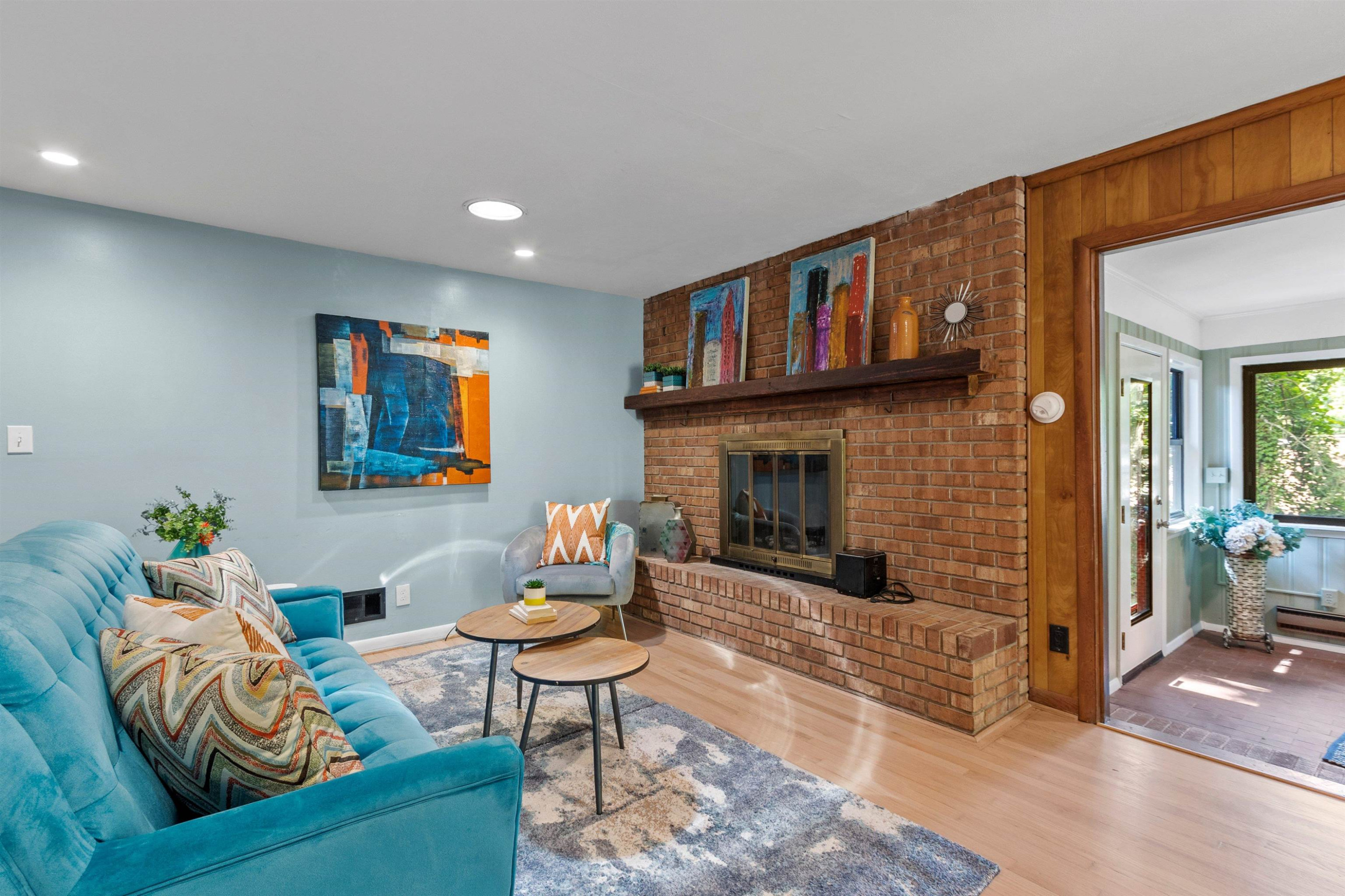 3207 Cyanne Circle Raleigh, NC 27606 - Photo 42 of 43 This family room is cozy and comfortable, especially with the masonry fireplace. Hardwood floors throughout the home are perfect for the mid century modernist build. Family Room