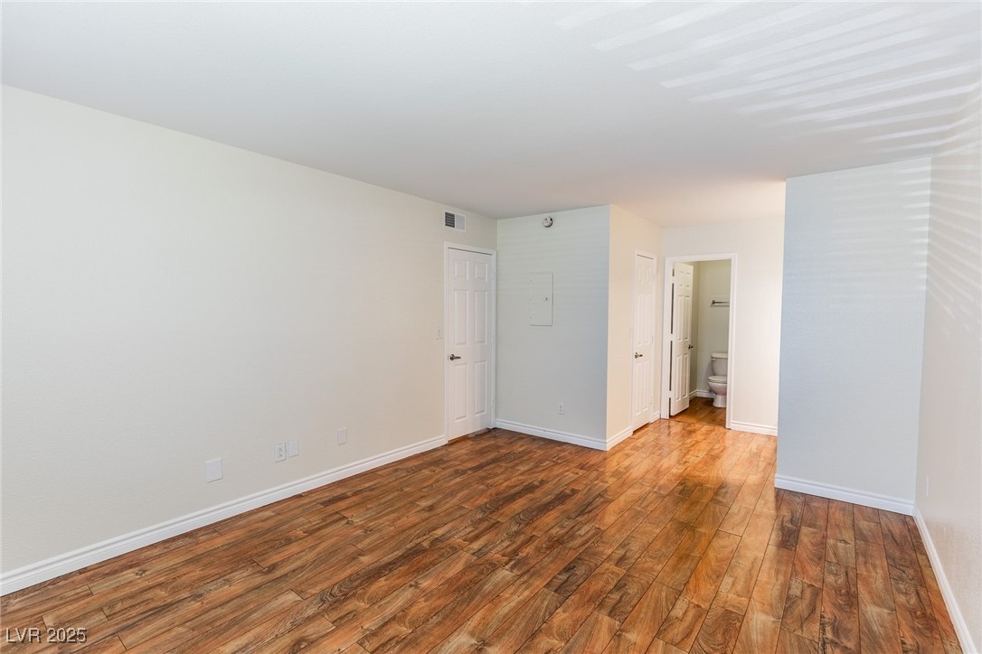 2451 North Rainbow Boulevard, Unit 1116 Las Vegas, NV 89108 - Photo 15 of 28 Unfurnished room featuring wood finished floors and baseboards