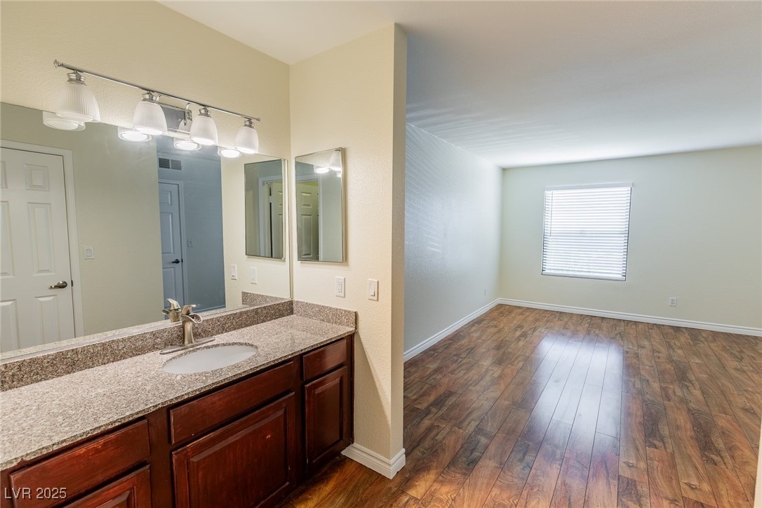 2451 North Rainbow Boulevard, Unit 1116 Las Vegas, NV 89108 - Photo 19 of 28 Bathroom featuring vanity and wood finished floors