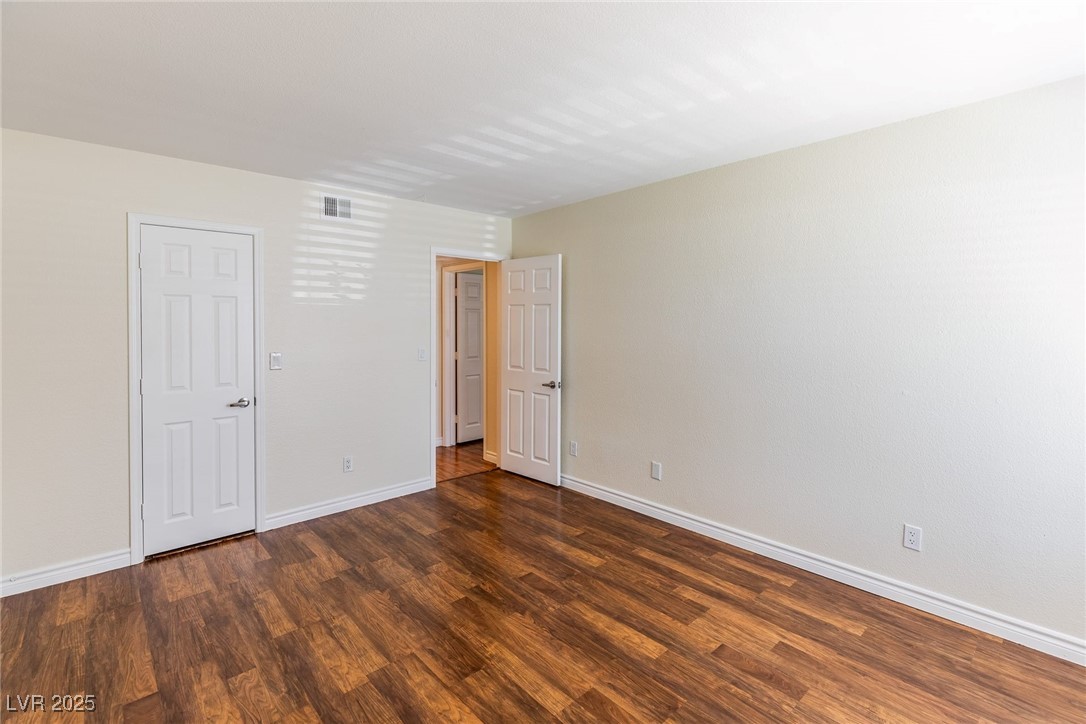 2451 North Rainbow Boulevard, Unit 1116 Las Vegas, NV 89108 - Photo 21 of 28 Unfurnished room with wood finished floors and baseboards