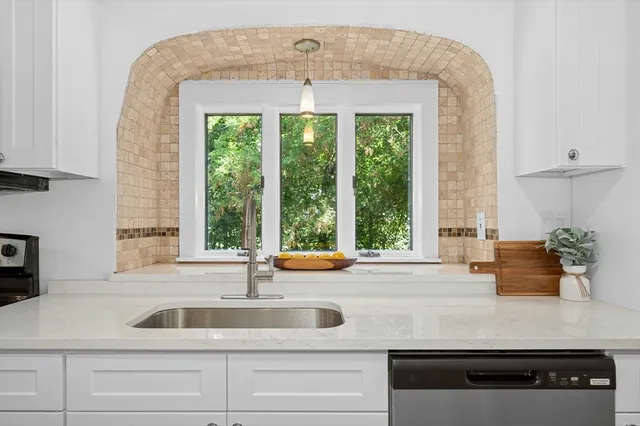 a kitchen with a sink and large window