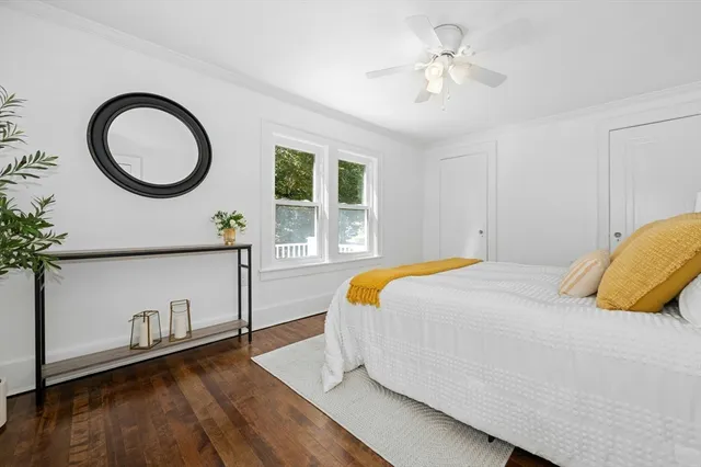 a bedroom with a bed and a large window