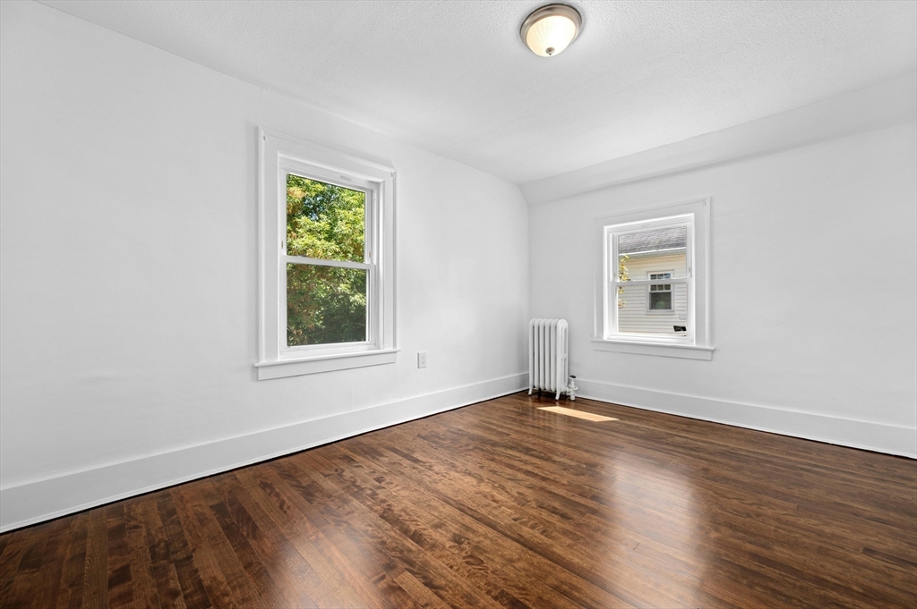 5 Coombs Road Worcester, MA 01602 - Photo 25 of 38 a view of an empty room with wooden floor and a window