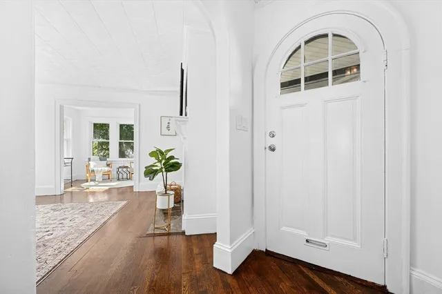 a view of an entryway with wooden floor