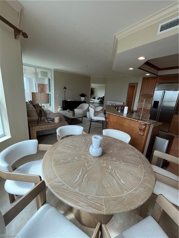 285 Grande Way, Unit 701 Naples, FL 34110 - Photo 12 of 20 a living room with furniture and a chandelier
