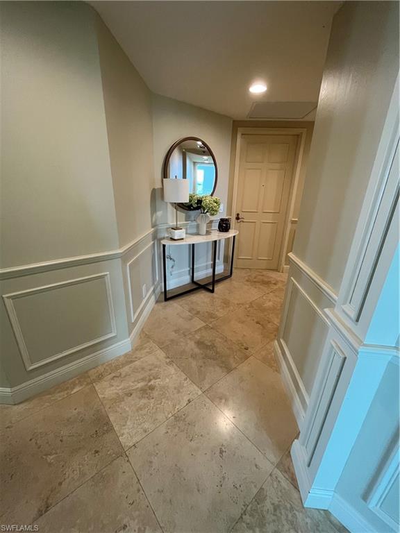285 Grande Way, Unit 701 Naples, FL 34110 - Photo 16 of 20 a view of a hallway with a car parked in living room