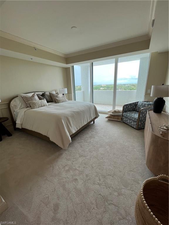285 Grande Way, Unit 701 Naples, FL 34110 - Photo 17 of 20 a spacious bedroom with a bed and glass walk in closet