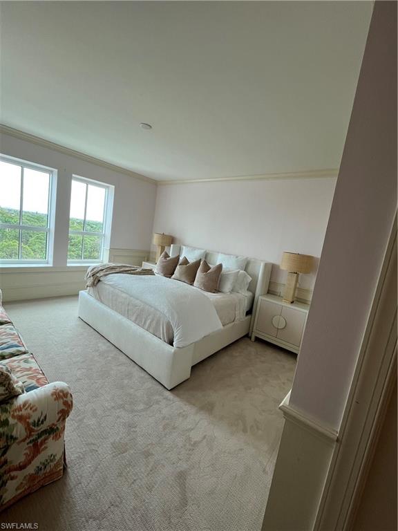 285 Grande Way, Unit 701 Naples, FL 34110 - Photo 19 of 20 a bedroom with bed couch and window