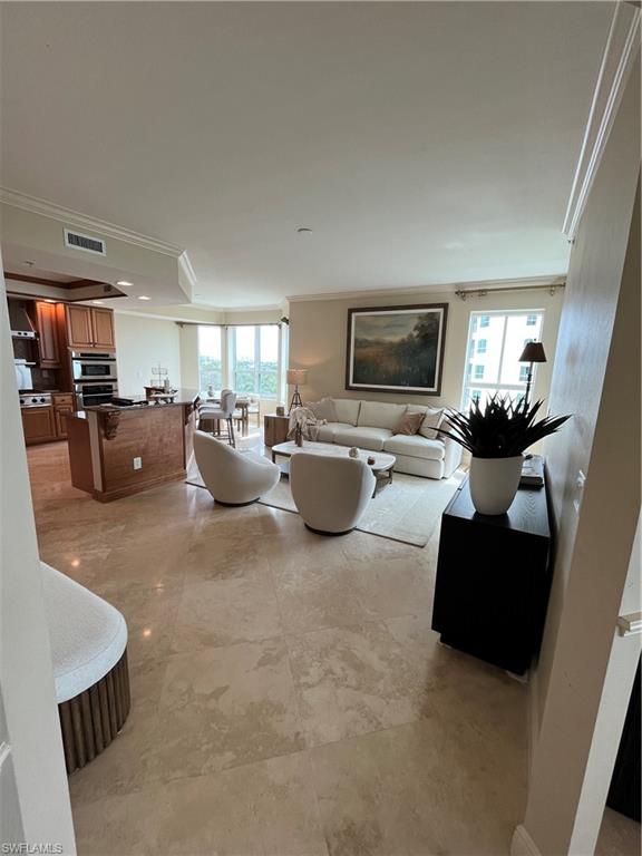 285 Grande Way, Unit 701 Naples, FL 34110 - Photo 9 of 20 a living room with furniture and a flat screen tv