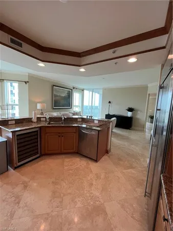 a large kitchen with a large counter top and stainless steel appliances