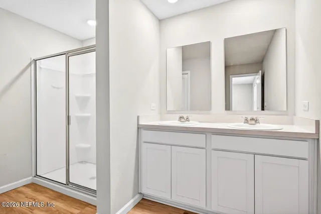 an empty room with a window and a ceiling fan