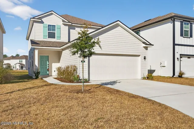 a view of an empty room with wooden floor and closet area