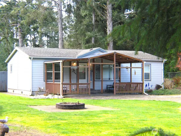 a backyard of a house with yard and trampoline