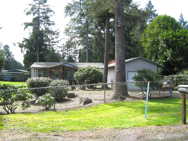 a view of a house with backyard and sitting area