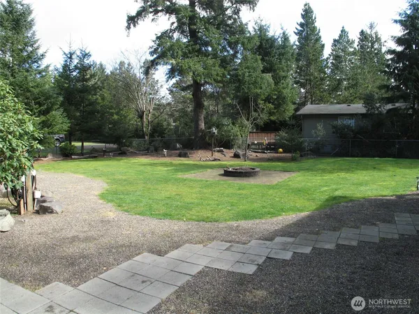 a view of a house with backyard and sitting area