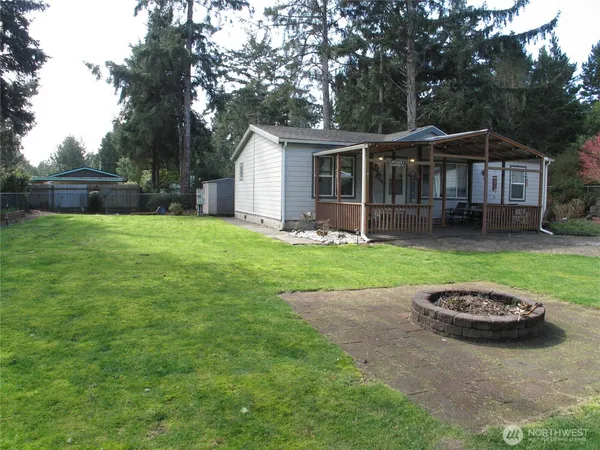 a view of a house with a backyard and a patio