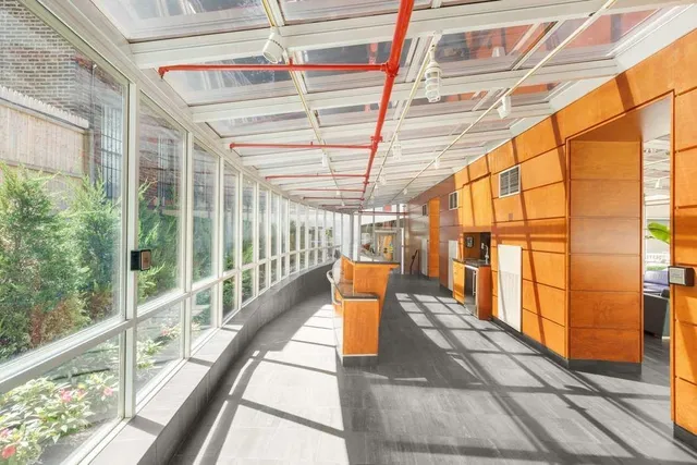 a view of a porch with wooden floor and windows