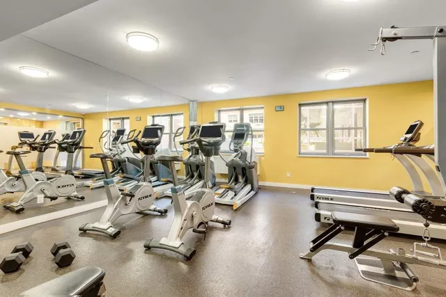 a room with gym equipment and a large window
