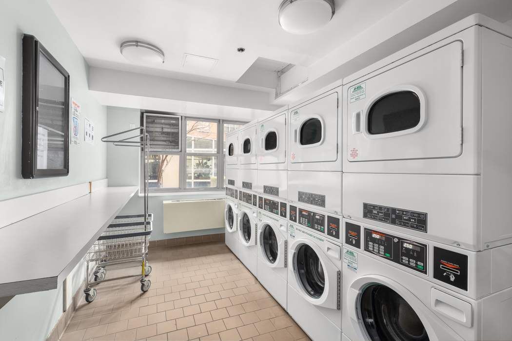 516 West 47th Street, Unit N6A Manhattan, NY 10036 - Photo 13 of 16 a utility room with dryer and washer