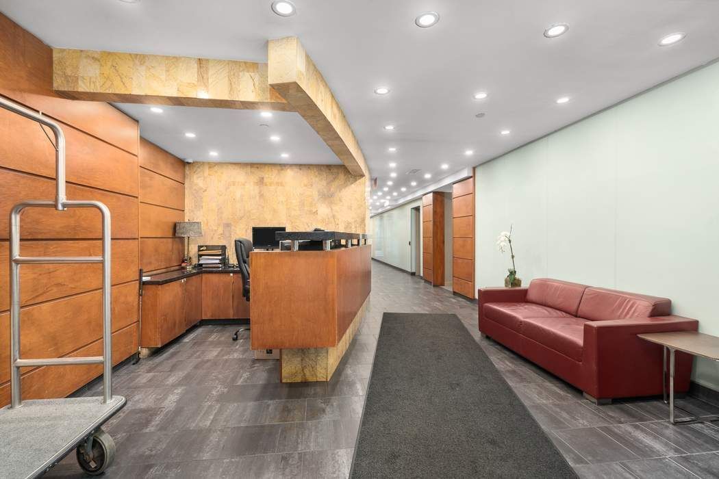 516 West 47th Street, Unit N6A Manhattan, NY 10036 - Photo 14 of 16 a living room with a couch and a table