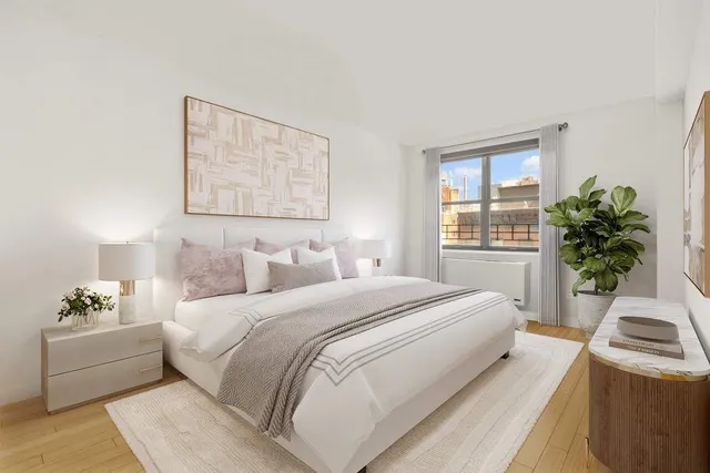 a spacious bedroom with a bed and a couch