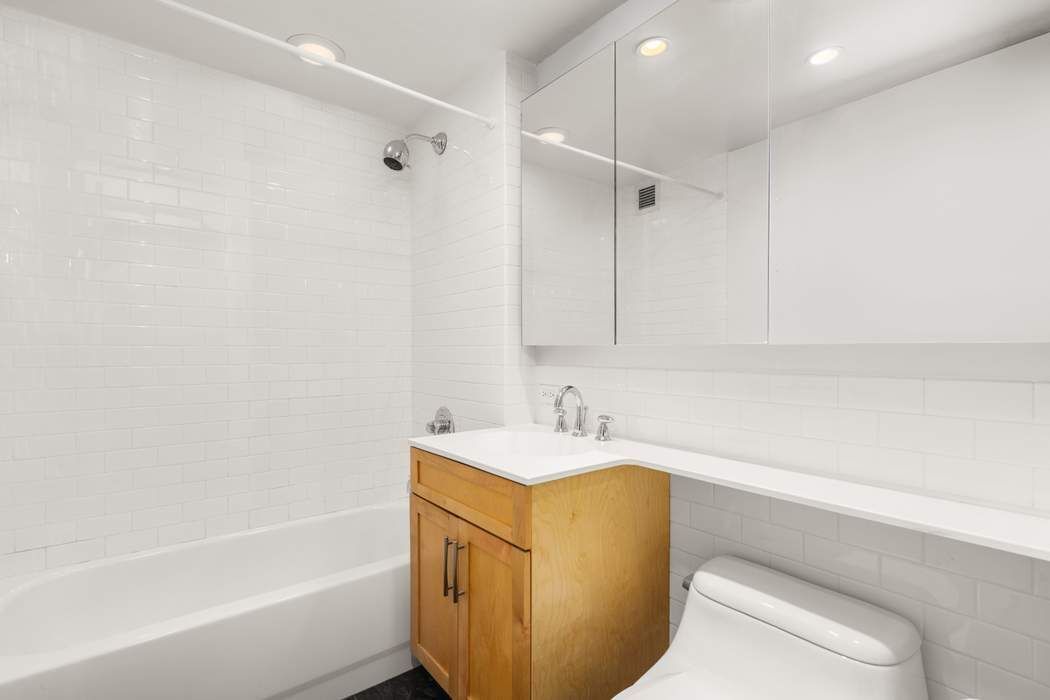 516 West 47th Street, Unit N6A Manhattan, NY 10036 - Photo 6 of 16 a bathroom with a sink and a bathtub