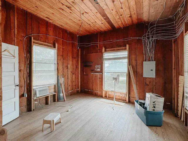 an empty room with wooden floor and closet
