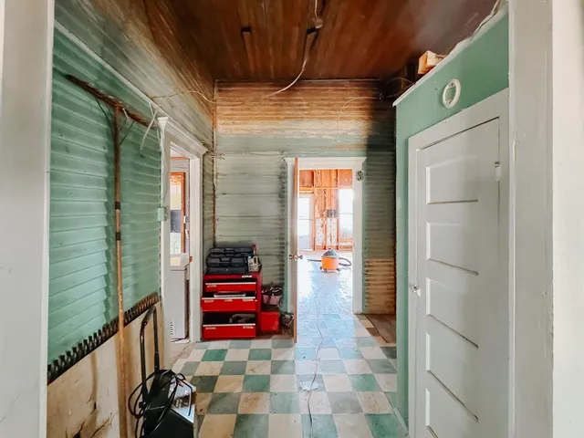 a front view of a house with porch and garden