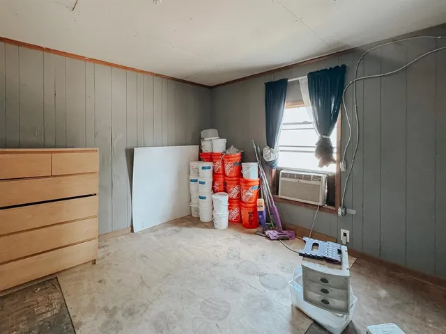 a view of a room with wooden floor and windows