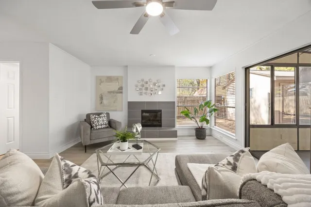 a living room with furniture chandelier and a fireplace