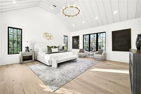 a bedroom with a bed mirror and window