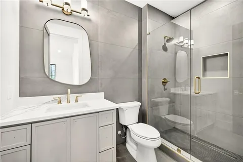 a bathroom with a toilet a sink and mirror