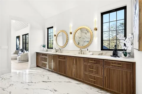 a bathroom with a toilet a sink and mirror
